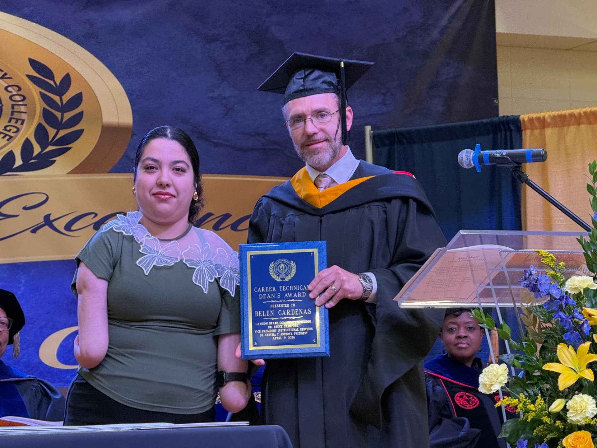 a girl is honored with certificate from faculty