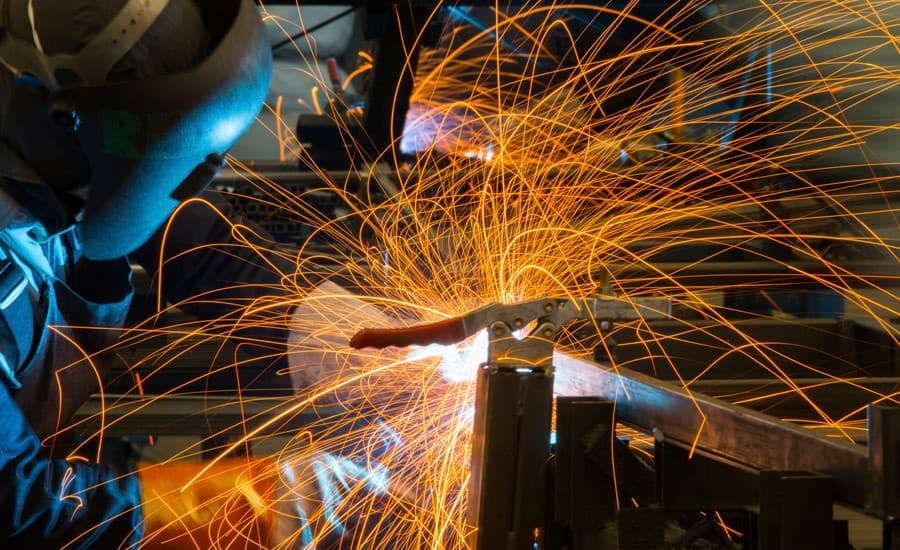 Welding student at a training bay