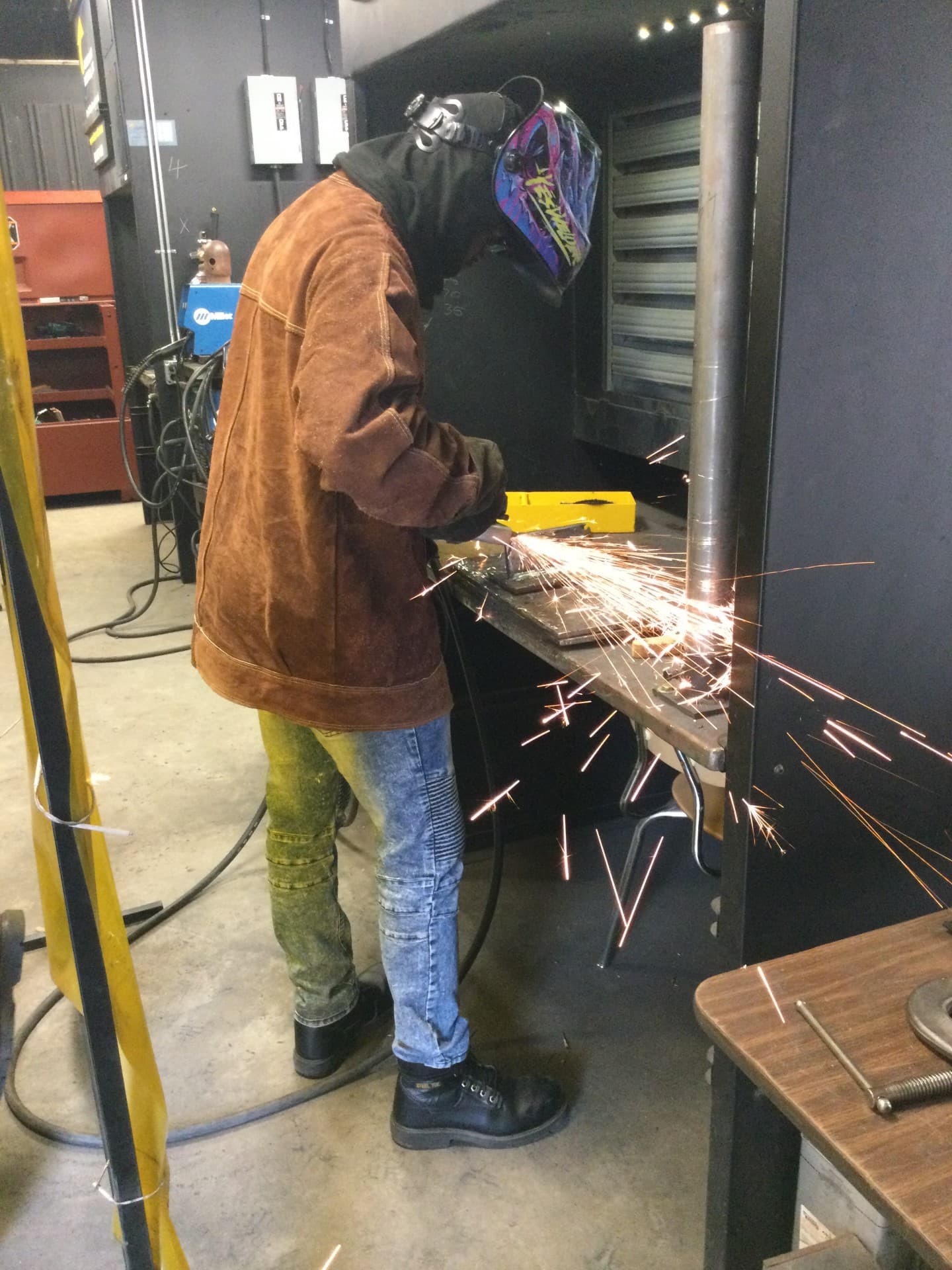 Welding student at a training bay