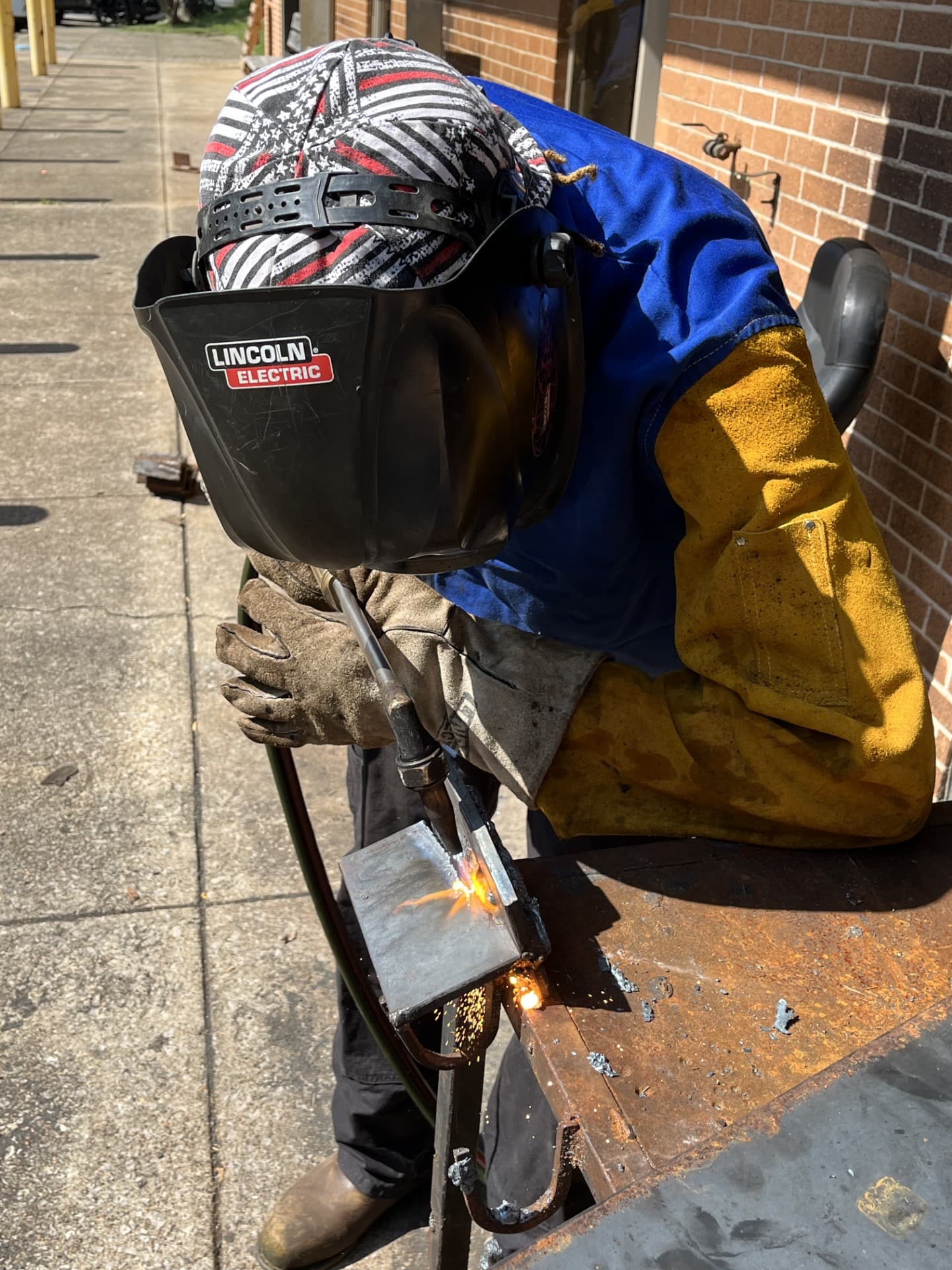 Welding student at a training bay